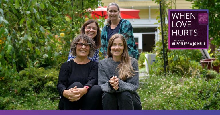 The When Love Hurts podcast team sit on the steps outside, smiling together.